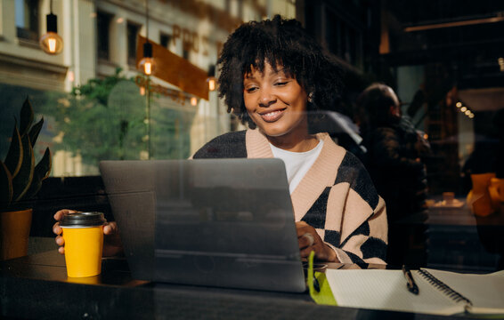 A woman using a laptop in a cafe