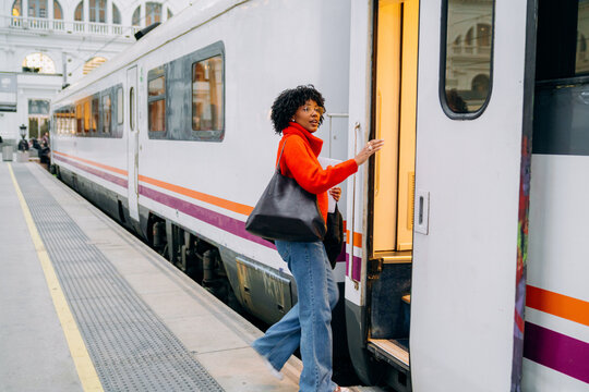 A woman boarding a train carriage