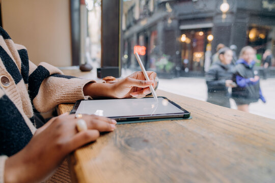 A woman using a tablet in a cafe