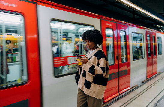A woman using a mobile phone in the subway