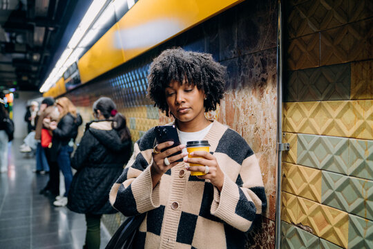 A woman using a mobile phone in the subway