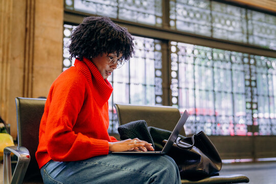 A woman uses a laptop in the waiting room