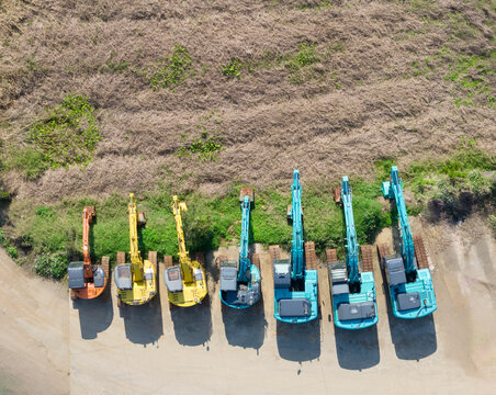 Aerial View of Colorful Excavators Parked in a Row