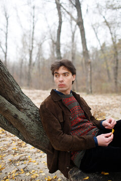 A man walks on the riverbank.
