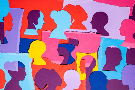 Colorful Paper Cutouts of Faces Arranged on a Bright Background