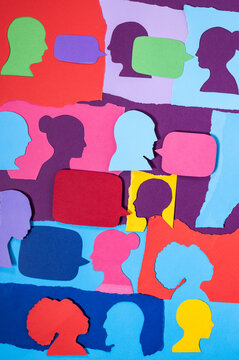 Bright Paper Cutouts of Faces Are Arranged on a Colorful Background