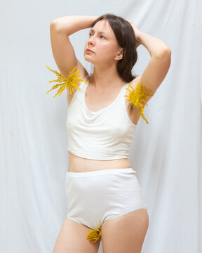 Young woman posing with flowers in her armpits 18