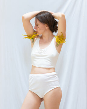 Young woman posing with flowers in her armpits 17