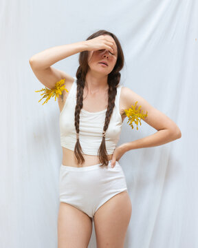 Young woman posing with flowers in her armpits 5