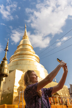 Tourist Takes Selfie at Golden Temple in Chiang Mai During Daytime