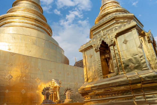 Golden Pagodas Shine Under the Blue Sky at a Temple in Thailand