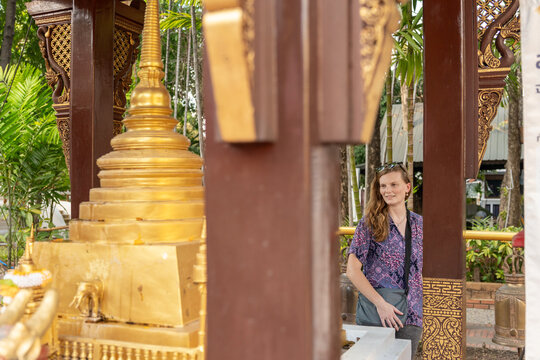 Woman Visits Golden Temple in Thailand During Sunny Day
