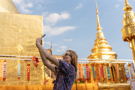 Visitors Take Selfies at Gold Temple in Thailand During Daytime