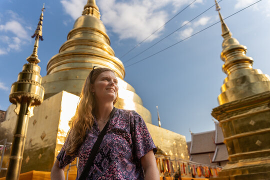 Visitor Smiles in Front of Golden Temples in Chiang Mai