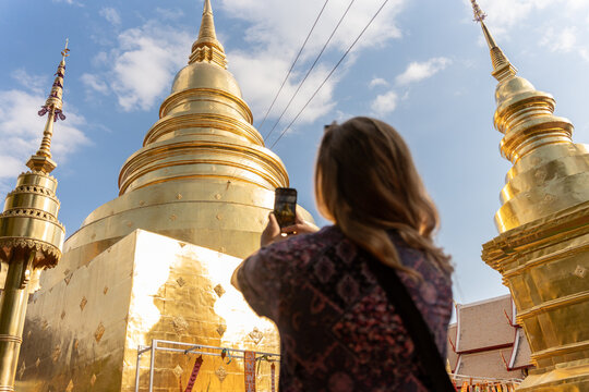 Tourist Takes Picture at Golden Temple During Sunny Day