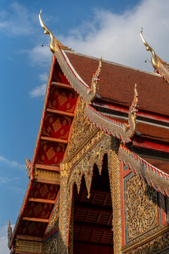 Temple Roof With Detailed Carvings Against Blue Sky