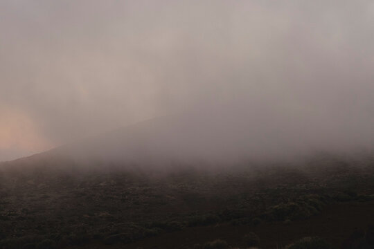 Pastel sunset sky over a mountain horizon.