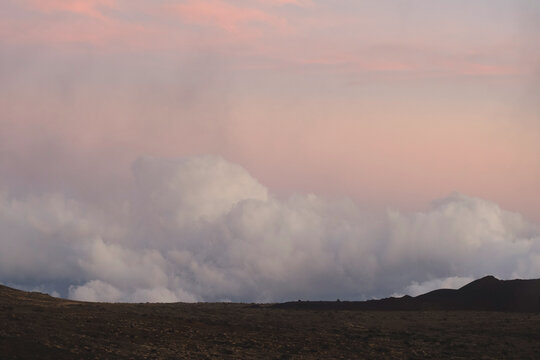 Pastel sunset sky over a mountain horizon.