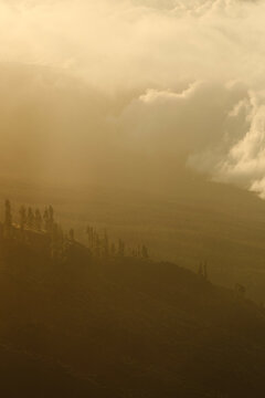 Mountain ridge silhouette under warm evening clouds.
