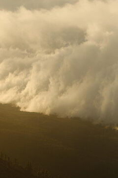 Mountain ridge silhouette under warm evening clouds.