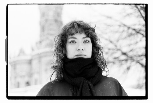 Film B&W Portrait of a Woman with Snow-Covered Hair in Blizzard