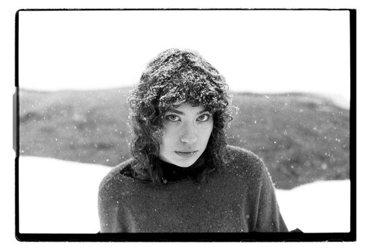 Film B&W Portrait of a Woman with Snow-Covered Hair in Blizzard