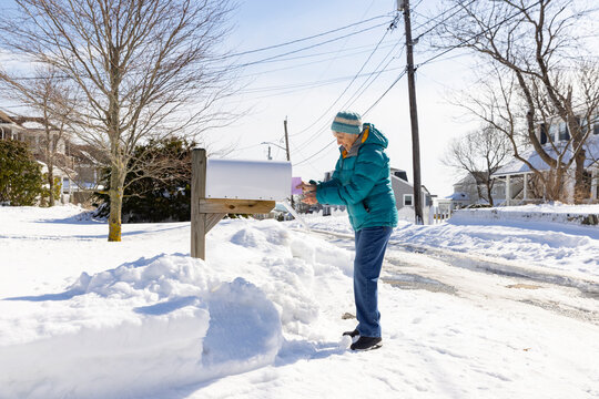 Senior woman gets mail from Mailbox 