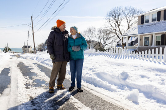 Senior couple winter walk smiling and talking 
