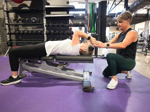 Fitness Training Session at a Gym With a Personal Trainer and Client