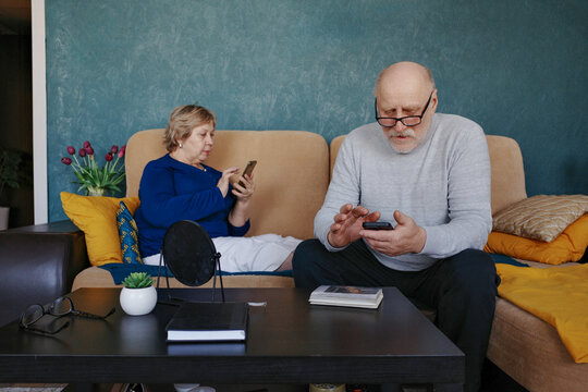 Senior couple connecting with digital devices
