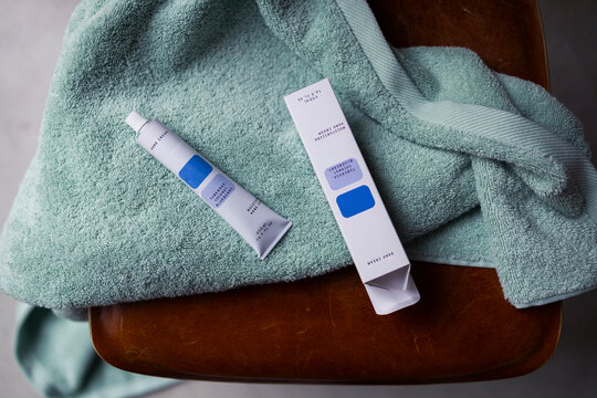Hand Cream Tube and Packaging on Mint Towel