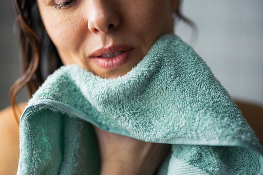 Woman Drying Her Face With Green Towel After Shower