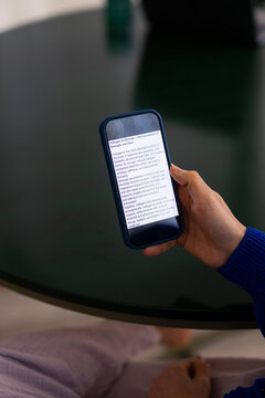 Person Reading Health Article On Smartphone At Table