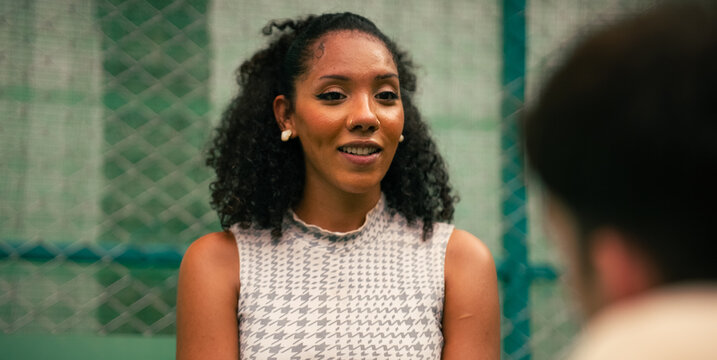 Young woman engaging in conversation during a pickleball game