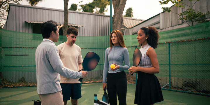 Pickleball instructor teaching rules and strategy to a friends group