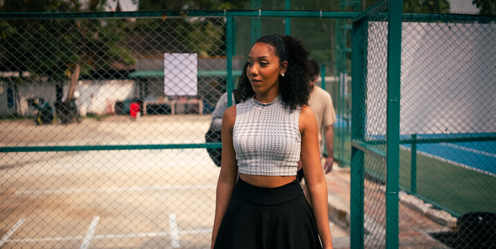 Woman walking on sports court, enjoying active lifestyle with friends