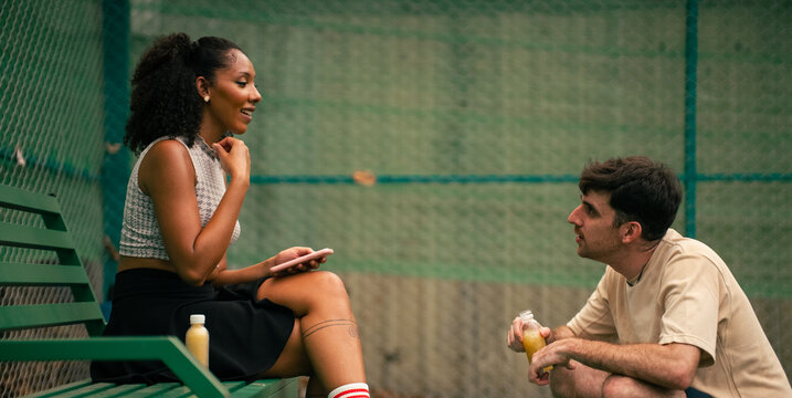 Friends talking and relaxing together after a pickleball game