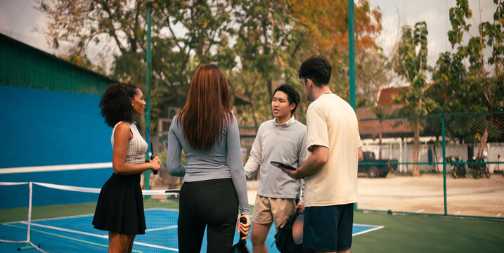 Friends discussing game rules on a pickleball court before the match