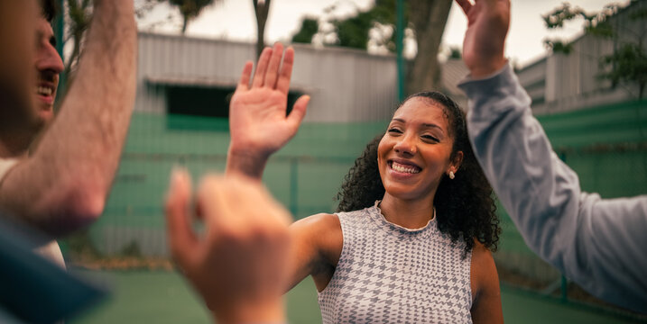 Friends giving high five, celebrating success and good teamwork
