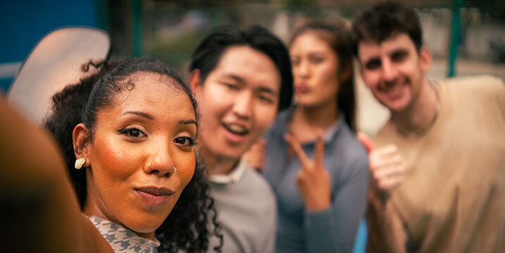 Friends enjoying time together taking a group selfie on court