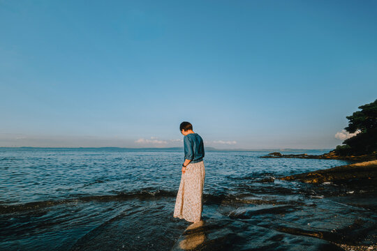 An Elegant Woman Seeking a Moment of Serenity at Sunset.