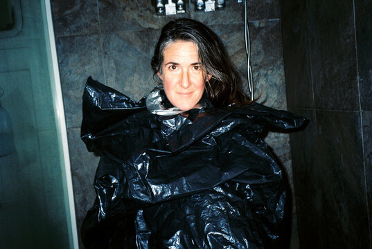 Woman with broken arm showers with a trash bag over her head