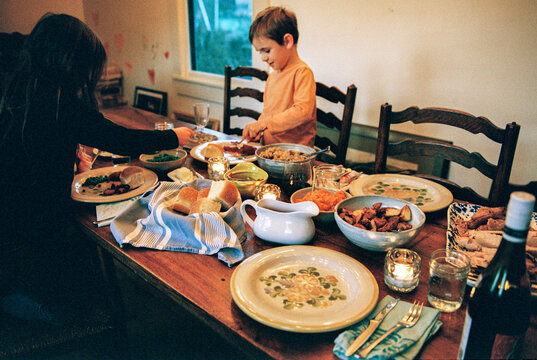 Family serving Food at the Thanksgiving dinner Table