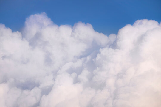 Fluffy white clouds and blue sky background