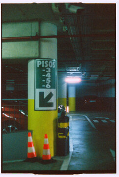 Underground Parking Garage With Direction Sign and Cones