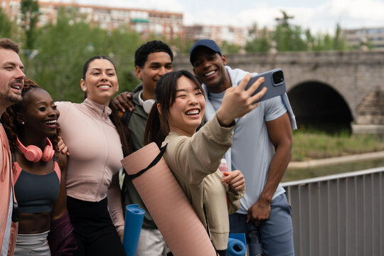Friends taking a group selfie outdoors