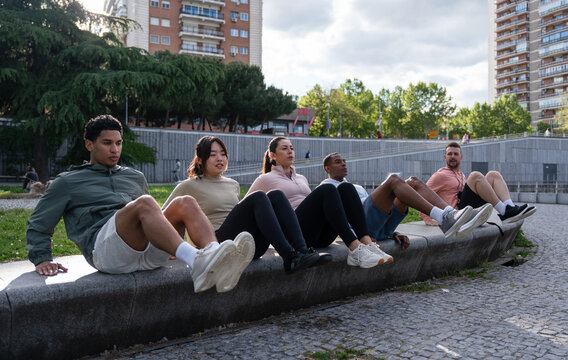 Group of people exercising outdoors on sunny day