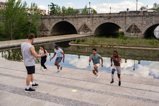 Outdoor fitness training near a historic stone bridge