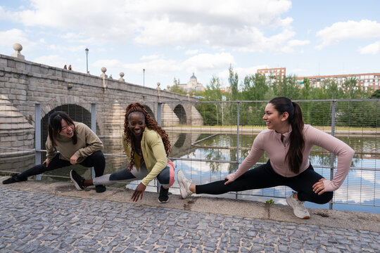 Outdoor stretching by the river with three women