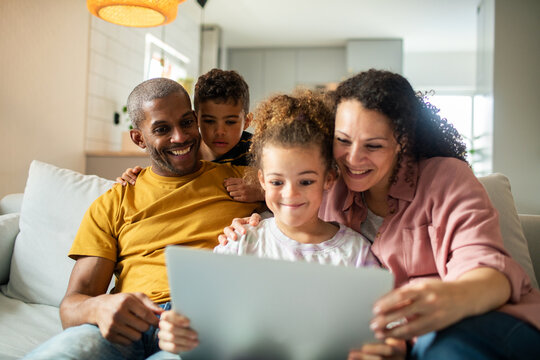 Happy family using tablet together at home